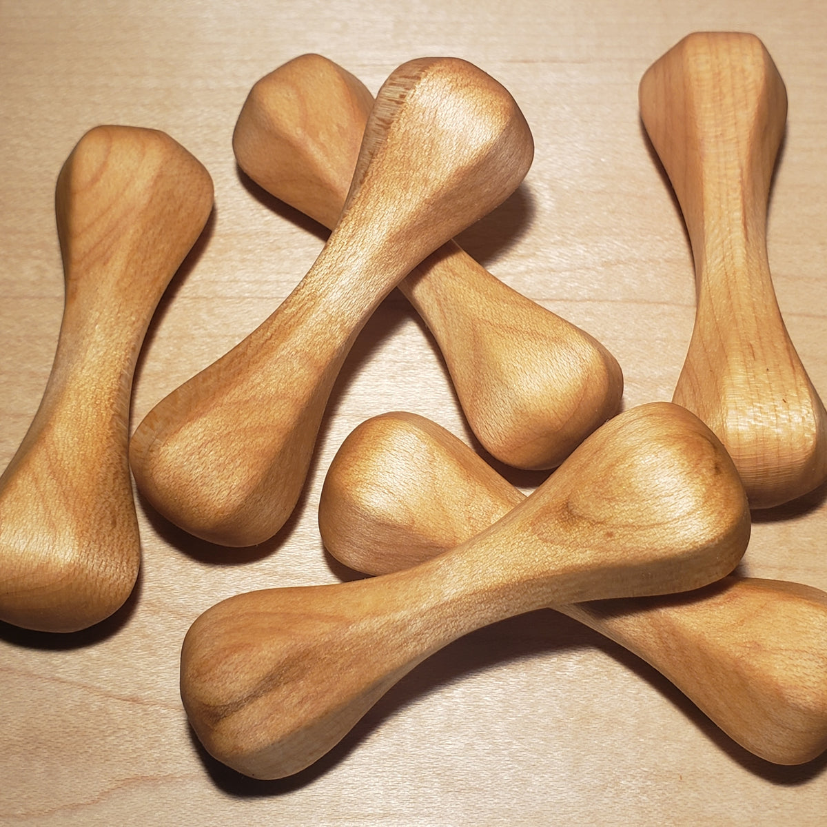 A group of maple wood knuckle roller pocket sculptures.
